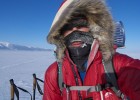 Photo of Andrew Skirka in heavy winter clothing hiking through Alaska.