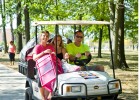 Photo of a freshman girl and her parent on a golf cart.