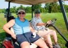 Photo of (From L to R) Marge Morgan and retired WSU employee Mary Ann Nafz pose in their golf cart at the employee golf outing at Twin Base Golf Club.