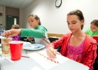 Photo of (L-R) Erica Whitcomb, Kylie King and Laura Polanka painting in “Wonderful Watercolors” class.