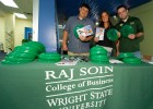 Photos of the Raj Soin College of Business table with green frisbees.