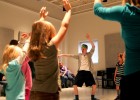 Photo of a student leading an acting class.