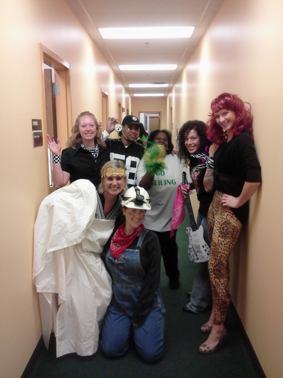 Photo of employees from the Admissions and Financial Aid offices dressed up for Halloween at the office.