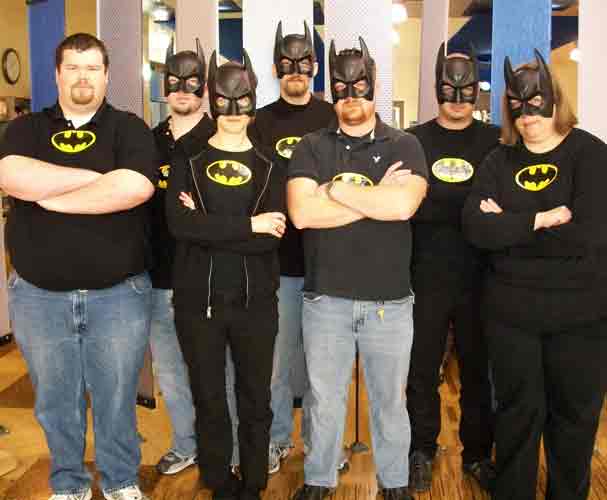 Photo of employees from the Library Computing Services Department each dressed as Batman.