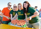 Photo of Dan Baker, Michelle Shreck and Kimberly Trame showing off their cupcakes during the Cupcake Wars contest at Raider Fest.