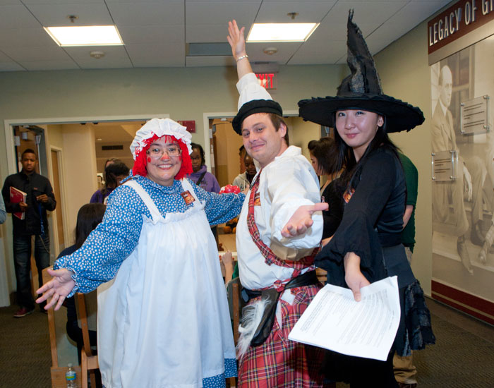 Photo of three people in costumes.
