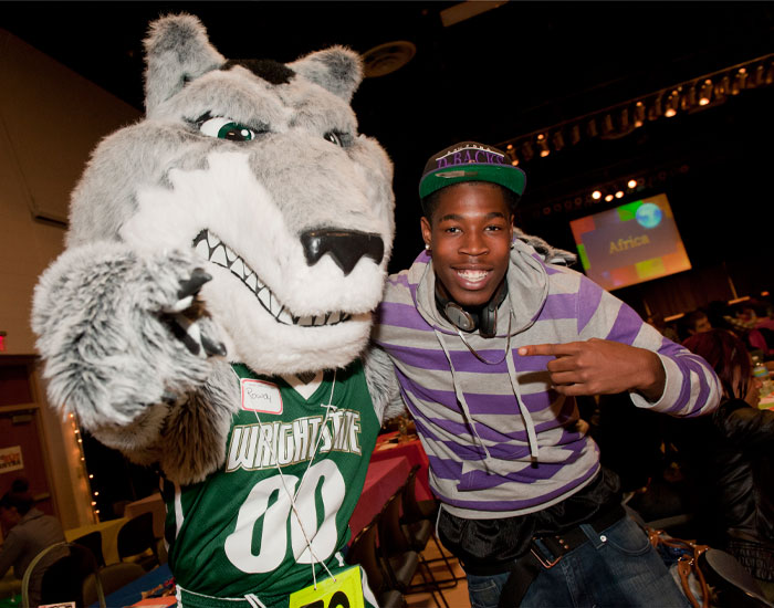 Photo of Rowdy Raider with a student