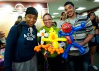 Photo of three students with balloon animals.