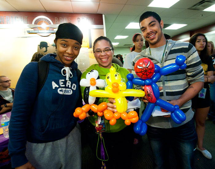 Photo of three students with balloon animals.