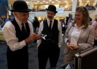 Tom Benson (left) and Roger Storm of the NASA Glenn Research Center in Cleveland, impersonating Wilbur and Orville Wright, examine micro air vehicles with Amanda Wright Lane during Wright Brothers Day in the Student Union Atrium. Wright Lane is the great-grandniece of the real Wright brothers.