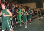 Photo of the men's basketball team greeting fans.