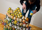 Photo of a man stacking canned food.