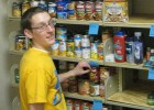 Photo of a student helping stock the Wright State Friendship Food Pantry