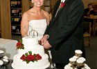 Photo of Ran and Mary Raider cutting their wedding cake.