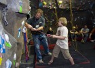 Photo of local elementary student getting a climbing lesson at the Wright State climbing wall.