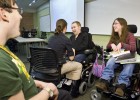 Photo of physicaly disabled Wright State students talking in a classroom.