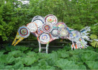 Photo of a sculpture of a peacock made out of recycleables