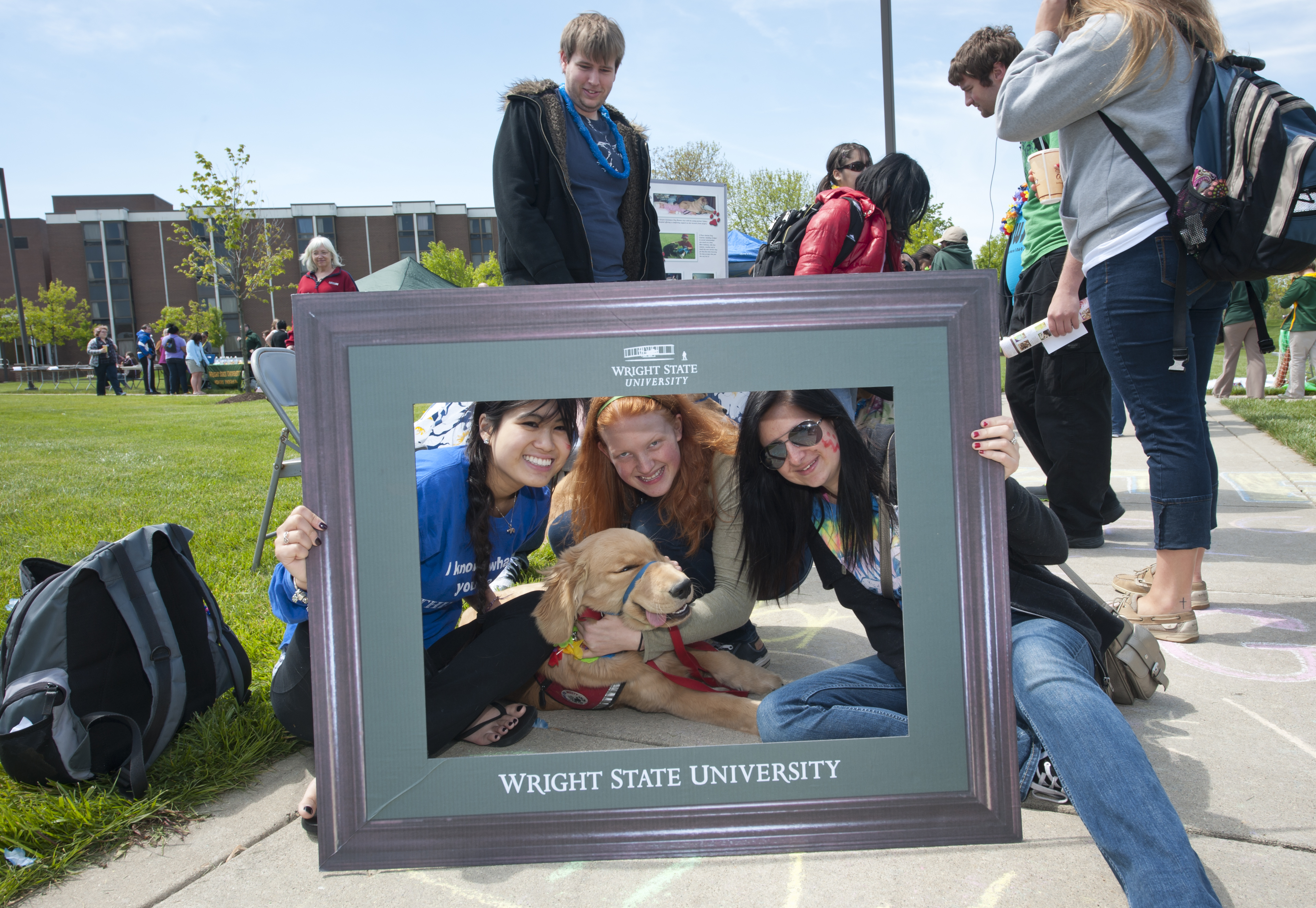 Photo of student posing with over-sized picture frame.