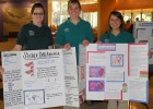Photo of three students with poster presentations