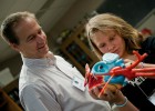 Photo of Wright State professor and a young girl examining a model of a heart.