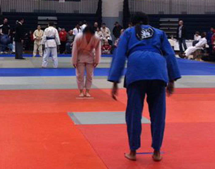 Photo of two people preparing to fight in a judo tournament.