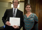 Photo of Bruce Kline, president of the board of directors of the Wright State Alumni Association accepting the Outstanding Nonprofit Organization Award on behalf of the association. At right, graduate student Amanda Turner also won a $250 scholarship.