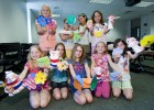 Photo of several pre-college students showing off their creations from their Sewing Creations class.