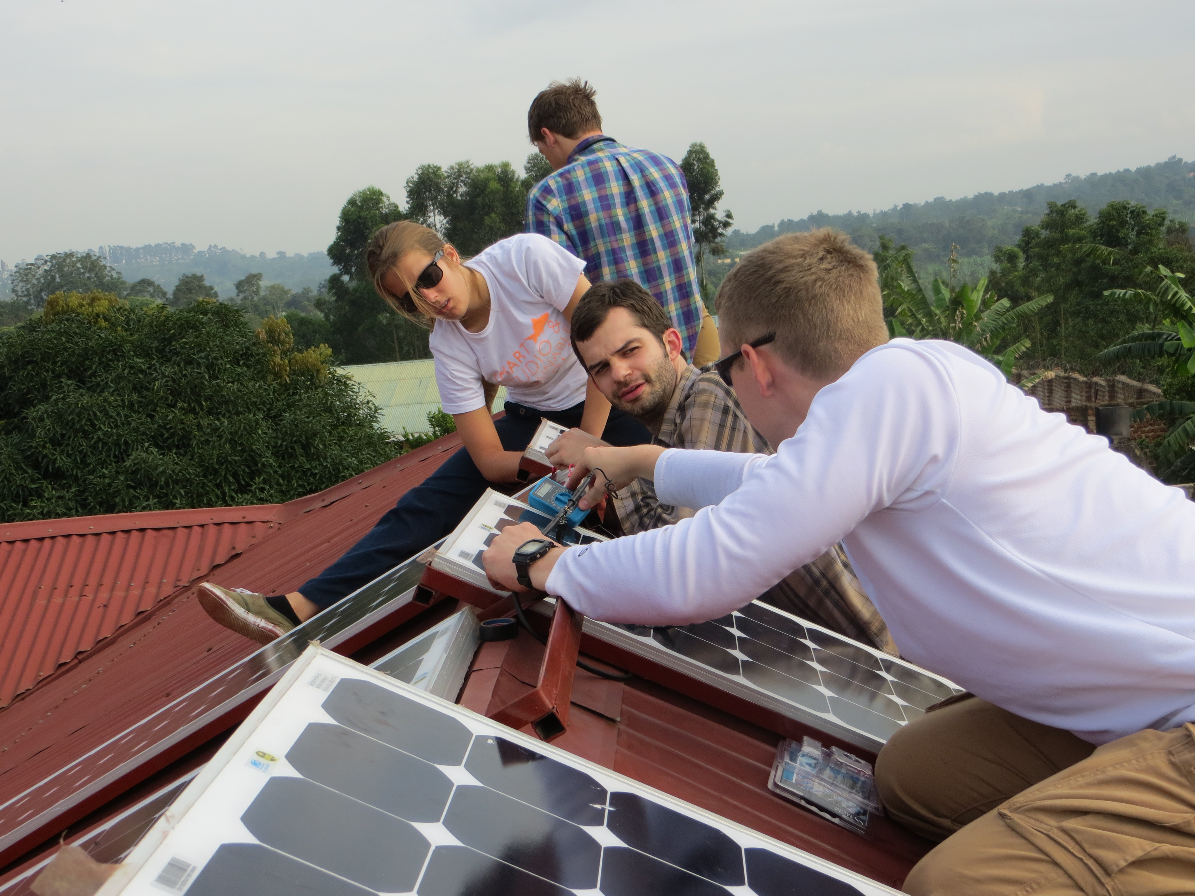 Photo of Wright State engineering students installing solar panels at the Ugandan clinic.