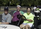 Photo of a Wright State freshman, her father and a volunteer on a golf cart.