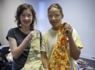 Photo of pre-college students Caroline Celaney (left) and Maryana Petrova showing their work from the Cretive Sewing class.