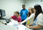 Photo of Collin Clark, Josh McLean, Tristan Pant and Kristine Kim using software to solve a crime in Forensic Analysis camp.