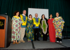 Photo of Wright State Presidnet David R. Hopkins and Immersion Day participants on stage dressed in ethnic gowns.