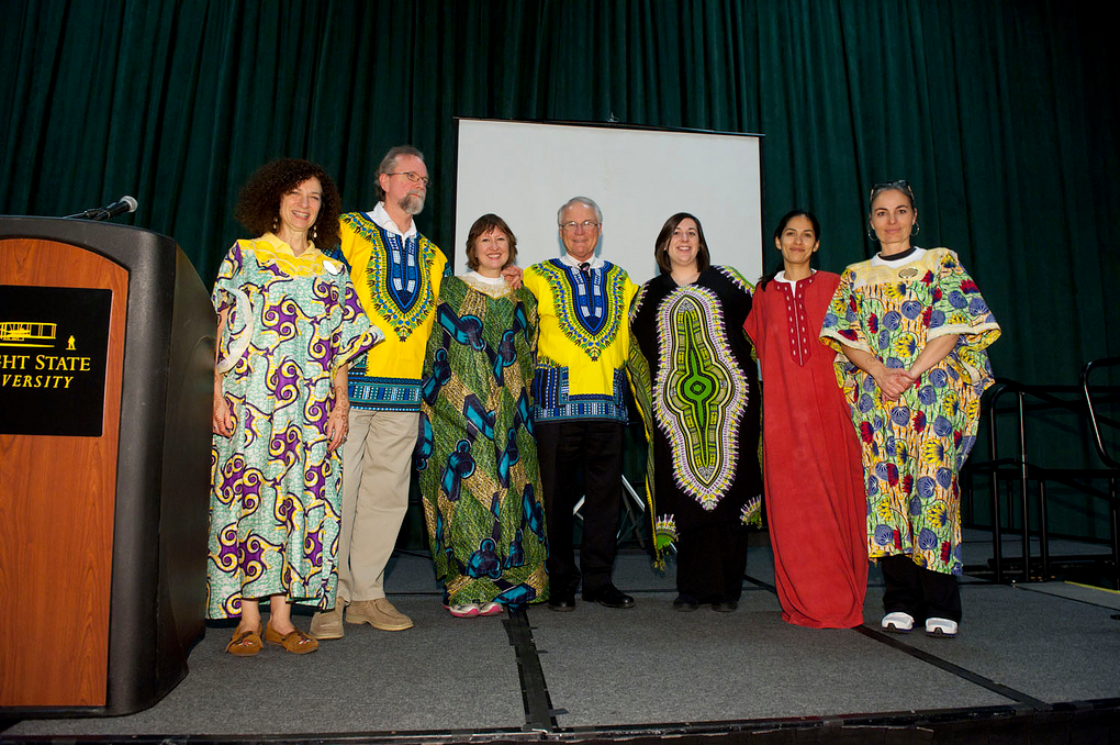Photo of Wright State Presidnet David R. Hopkins and Immersion Day participants on stage dressed in ethnic gowns.