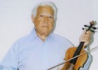 Photo of Robert Kahn with a violin
