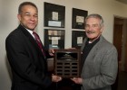 Photo of Larry James, Ph.D., dean of the School of Professional Psychology (left); and Jerry Yung, husband of the late Betty Yung, an associate professor at SOPP, display a plaque marking The Dr.Betty Yung Awards.