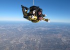 Photo of Wright State's Herb Dregalla (in yellow suit) skydiving with an Army Golden Knight