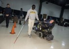 Photo of an able-bodied student walking blindfolded with a blind person's walking stick.