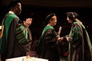 Margaret Dunn presents graduate with a diploma