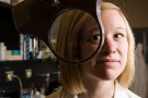 Elizabeth Harris looking through magnifying glass.