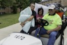 Golf cart with pillows and people