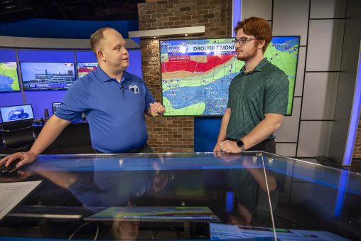 Ian Bates and WHIO meteorologist Nick Dunn talk about the weather at the WHIO studio in front of a radar screen.