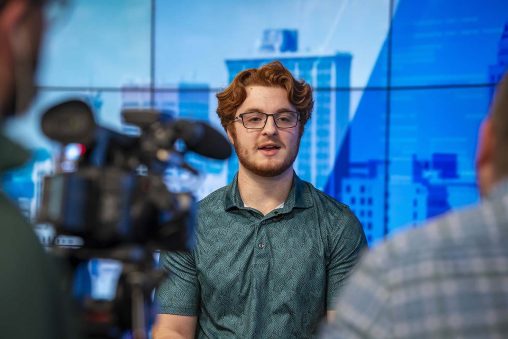 Ian Bates talks to reporters inside the WHIO weather studio.
