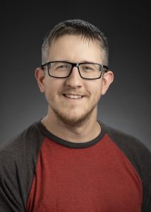 A man posing for a professional portrait.