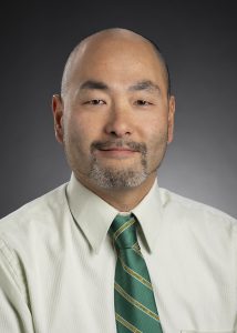 A man in business attire posing for a professional portrait.