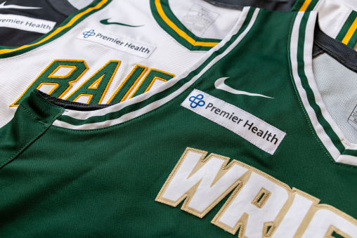 Two Wright State basketball jerseys laying overlapped with a Premier Health patch in the corner of each.