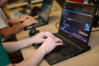 A person types on a laptop computer.